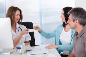 Nurse and patients going over insurance