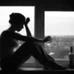 Woman-In-Depressed-Mood-Sits-O-89032895