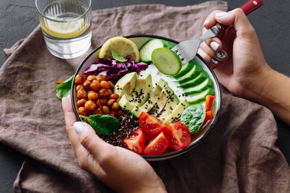 hands around a bowl holding a healthy lunch