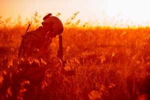 while sitting in a field, a veteran soldier struggles with ptsd and substance abuse